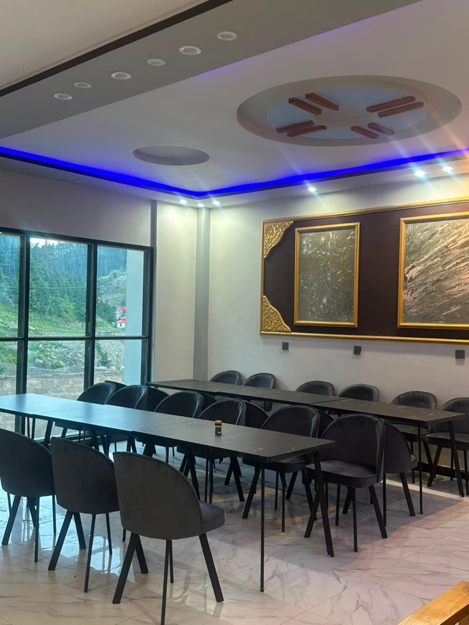 Hotel restaurant with mountain views and blue LED ceiling