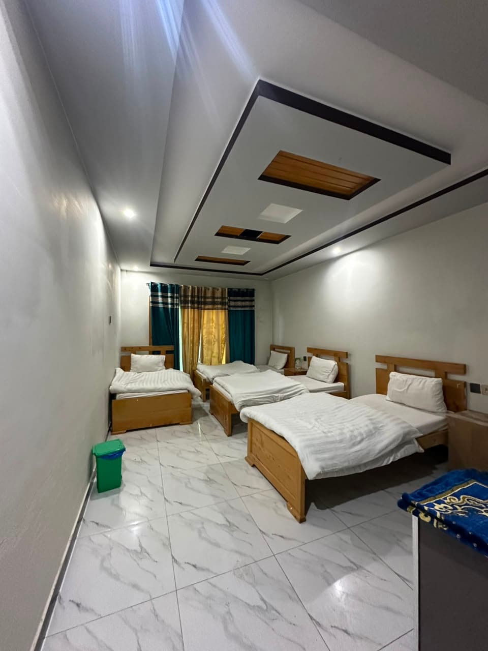 Large four single bed room for groups at Comfort Inn Kalam